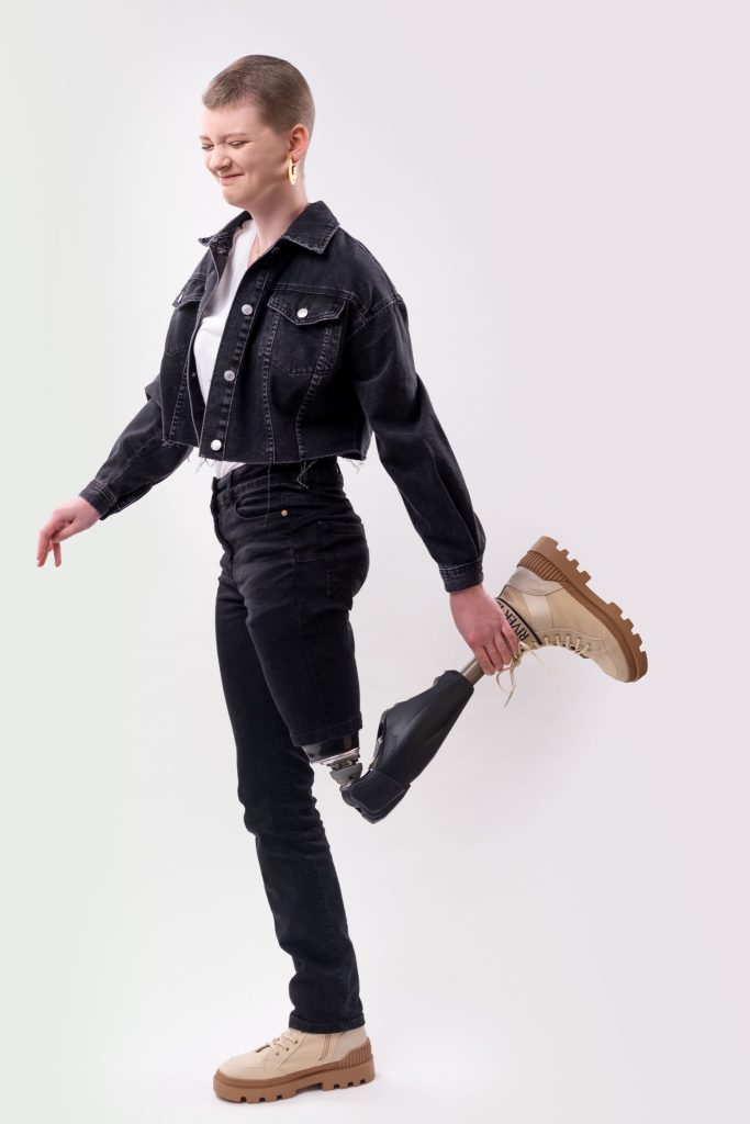 full body portfolio photo of a female diversity model balancing on one leg