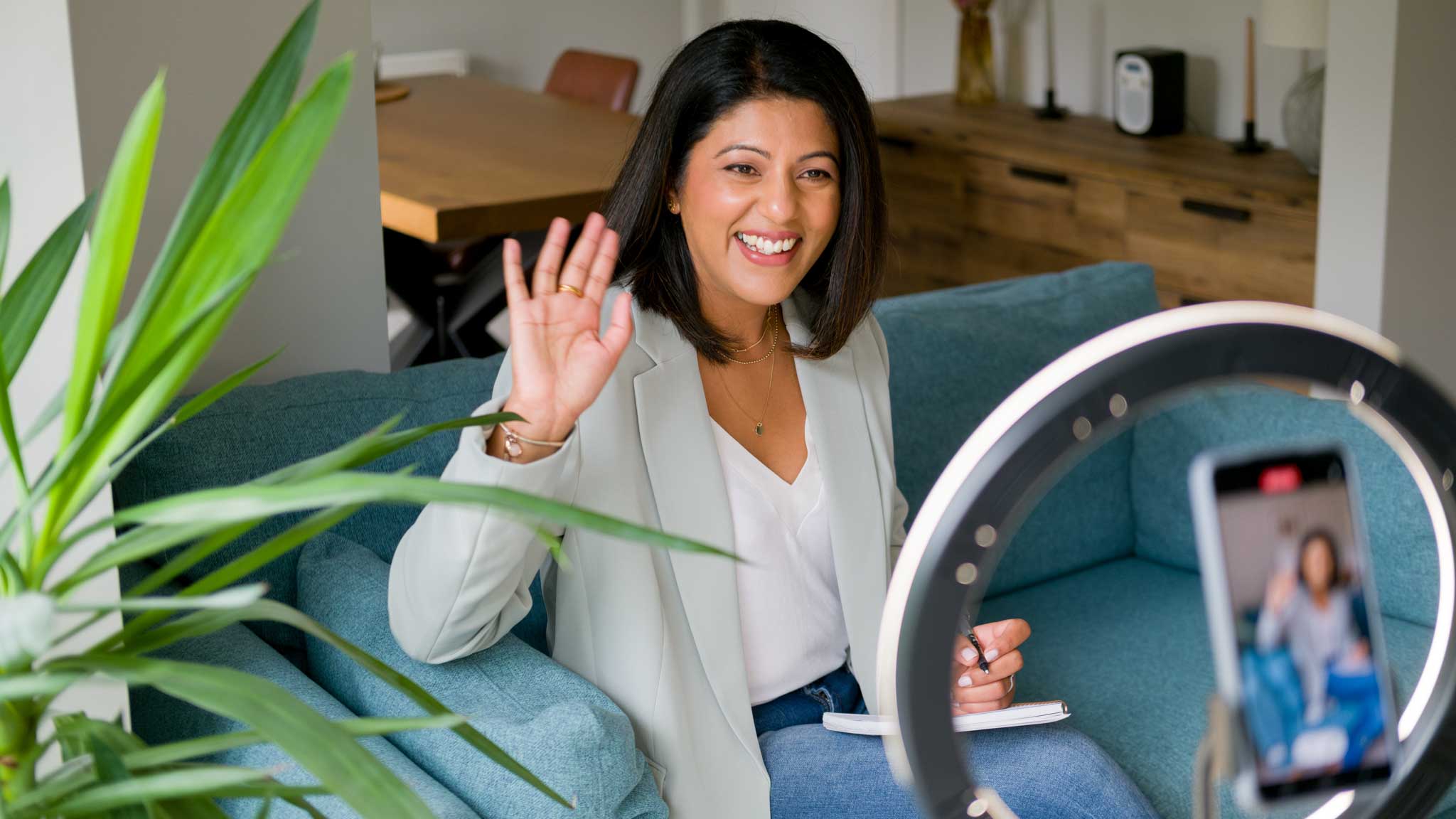 Woman smiling and waving to the camera. Personal branding photography for a marketing expert