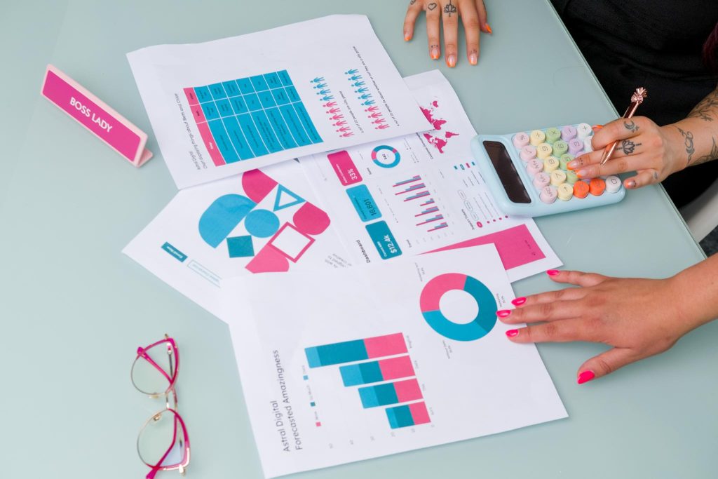 brand photoshoot with a marketing agency. Detail photo of hands holding a calculator and documents