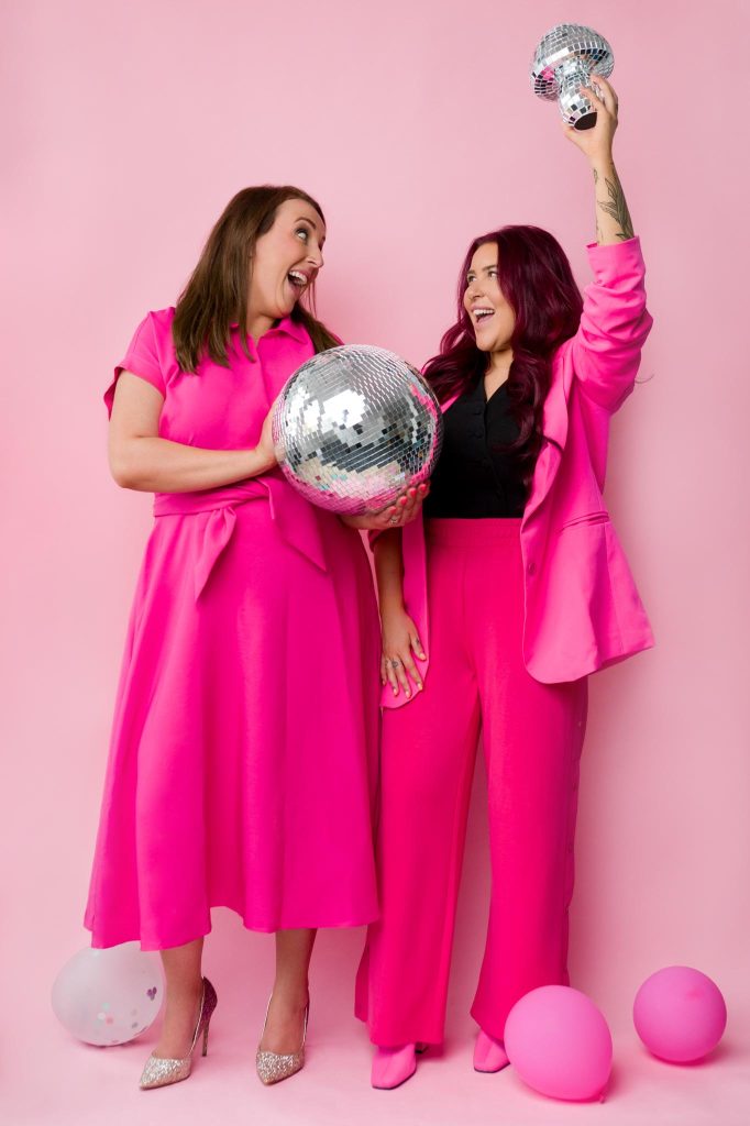 creative brand photography for a marketing agency. Two women wearing pink dancing with disco balls