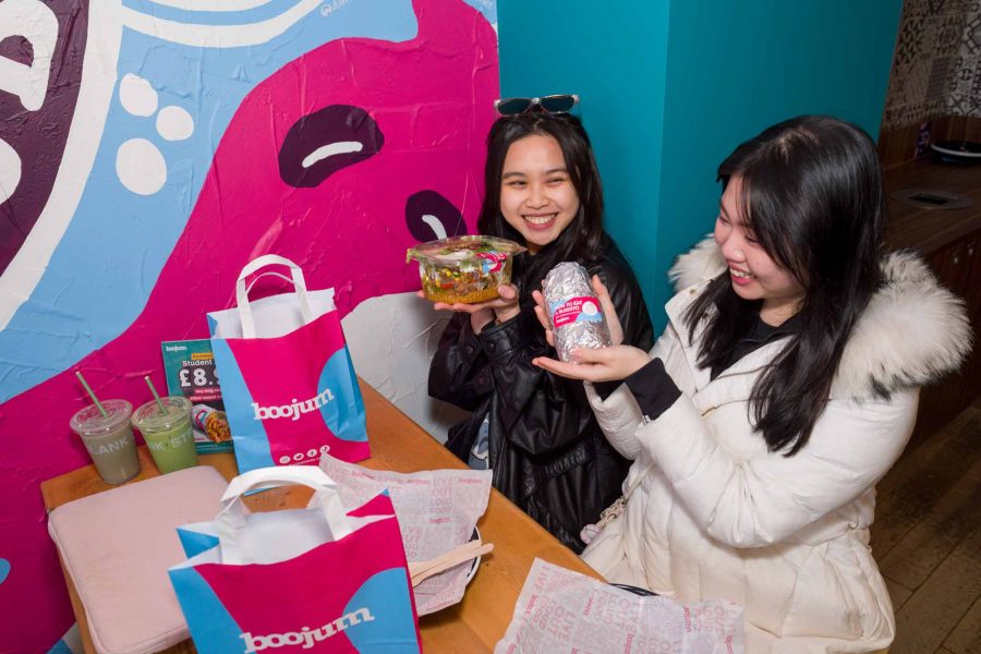 burrito bar opening event, customers posing with their meals for social media content