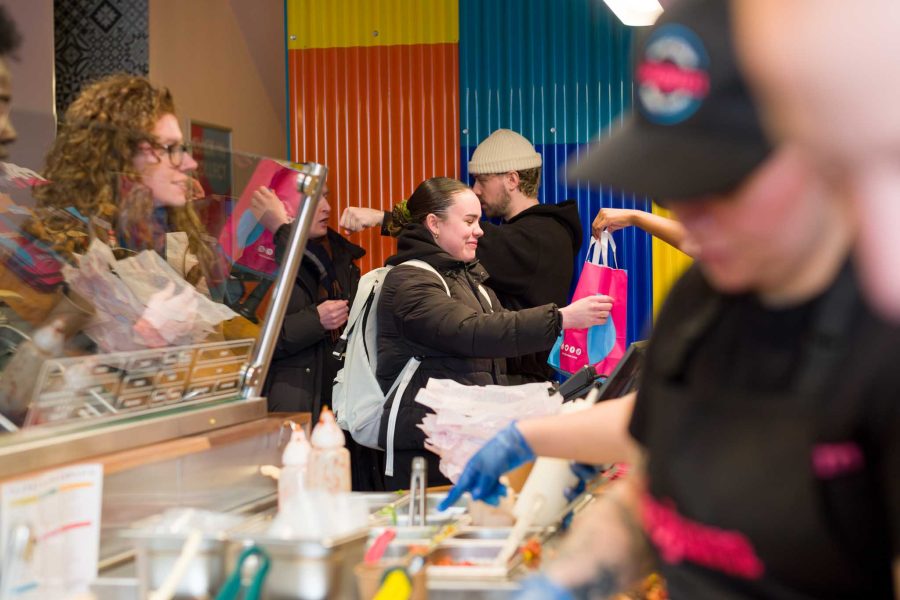 restaurant marketing photography. Smiling customer picking up their order